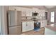 Modern kitchen showcasing stainless steel appliances, sleek white cabinets, and ample counter space at 1390 E Wabash St, Bartow, FL 33830