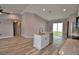 Modern kitchen flows into living area, with stainless appliances, island, and access to the patio at 1390 E Wabash St, Bartow, FL 33830