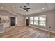 Bright living room with wood floors, modern ceiling fan and large window at 1390 E Wabash St, Bartow, FL 33830
