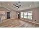 Bright living room featuring updated flooring, fresh paint, and a modern ceiling fan at 1390 E Wabash St, Bartow, FL 33830