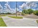 Street view showcasing sidewalk, utility poles, and other homes across the street at 1390 E Wabash St, Bartow, FL 33830