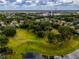 Aerial shot of a residential area featuring manicured lawns, mature trees and a tranquil lake with a fountain at 14003 Hampshire Bay Cir, Winter Garden, FL 34787