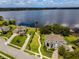 Picturesque aerial view of waterfront homes with docks, manicured lawns, and lush landscaping near a tranquil lake at 14003 Hampshire Bay Cir, Winter Garden, FL 34787