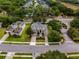 Aerial view of a distinguished residence with lush landscaping, a three-car garage and a stately entrance at 14003 Hampshire Bay Cir, Winter Garden, FL 34787