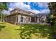 Expansive backyard featuring lush green lawn, screened-in pool area and mature trees perfect for outdoor entertaining at 14003 Hampshire Bay Cir, Winter Garden, FL 34787
