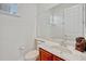 Bathroom features a large mirror, white countertop with single sink, and wood cabinets for storage at 14003 Hampshire Bay Cir, Winter Garden, FL 34787