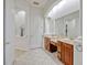 Bright bathroom featuring dual sinks and mirrors with views into the water closet at 14003 Hampshire Bay Cir, Winter Garden, FL 34787