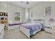 A serene bedroom features large windows with white trim and a comfortable bed with a galaxy themed comforter at 14003 Hampshire Bay Cir, Winter Garden, FL 34787