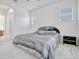Bedroom with natural light features a dark wood nightstand and bed frame, neutral walls and carpeting at 14003 Hampshire Bay Cir, Winter Garden, FL 34787