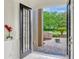 Open double front doors lead to a paver walkway and manicured front yard at 14003 Hampshire Bay Cir, Winter Garden, FL 34787