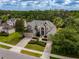 Beautiful two-story home with manicured landscaping, a large driveway, and a two-car garage at 14003 Hampshire Bay Cir, Winter Garden, FL 34787