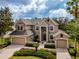 Elegant two-story home with a three-car garage, manicured landscaping and a paver driveway at 14003 Hampshire Bay Cir, Winter Garden, FL 34787