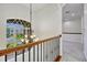 Hallway with wrought iron railing and an arched window offering natural light at 14003 Hampshire Bay Cir, Winter Garden, FL 34787