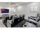 Home theater with tiered seating, comfy black leather recliners, and large flatscreen TV for entertainment at 14003 Hampshire Bay Cir, Winter Garden, FL 34787