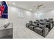 Spacious home theater room with plush seating and a large flat screen TV for immersive entertainment at 14003 Hampshire Bay Cir, Winter Garden, FL 34787