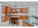 Kitchen with granite countertops, wooden cabinets, and a central island with bar stool seating at 14003 Hampshire Bay Cir, Winter Garden, FL 34787