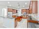 Spacious kitchen with dark cabinets, granite counters, a stainless steel refrigerator, and a central island at 14003 Hampshire Bay Cir, Winter Garden, FL 34787