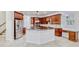 Bright kitchen featuring granite countertops, dark wood cabinets, and stainless steel appliances at 14003 Hampshire Bay Cir, Winter Garden, FL 34787