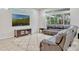 Spacious living room with large windows, a plush leather sofa, and a stylish area rug at 14003 Hampshire Bay Cir, Winter Garden, FL 34787