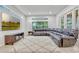 Bright living room with a big sectional sofa, large windows, and a modern entertainment center at 14003 Hampshire Bay Cir, Winter Garden, FL 34787