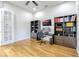 A well-lit office space with built-in bookshelves and hardwood floors, perfect for working from home at 14003 Hampshire Bay Cir, Winter Garden, FL 34787