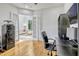 A well-lit office space with built-in bookshelves and hardwood floors, perfect for working from home at 14003 Hampshire Bay Cir, Winter Garden, FL 34787