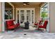 Tiled outdoor patio area with comfortable seating, a ceiling fan, and glass doors to the home's interior at 14003 Hampshire Bay Cir, Winter Garden, FL 34787