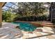Large private screened pool area featuring a spa and lush landscaping, perfect for relaxation at 14003 Hampshire Bay Cir, Winter Garden, FL 34787