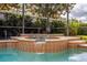 Private screened pool and spa feature lush landscaping, providing a serene outdoor retreat at 14003 Hampshire Bay Cir, Winter Garden, FL 34787