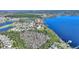 Scenic aerial view of the property nestled beside a serene lake, surrounded by lush greenery at 14906 Speer Lake Dr, Winter Garden, FL 34787