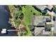Aerial view of a home with screened-in patio, a long dock, and lush green surroundings and access to the water at 14906 Speer Lake Dr, Winter Garden, FL 34787