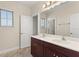 Bathroom featuring double sinks, stone counter, and dark cabinets at 14906 Speer Lake Dr, Winter Garden, FL 34787