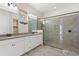 Modern bathroom featuring double sinks, a large walk-in shower, and neutral tile at 14906 Speer Lake Dr, Winter Garden, FL 34787
