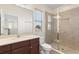 Bathroom featuring tiled shower, stone counter and brown cabinets at 14906 Speer Lake Dr, Winter Garden, FL 34787