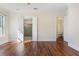 Bright, spacious bedroom with beautiful dark wood floors, white trim and two open doorways at 14906 Speer Lake Dr, Winter Garden, FL 34787