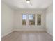 A bright bedroom with hardwood floors, natural light and a large window at 14906 Speer Lake Dr, Winter Garden, FL 34787