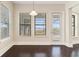 Sunlit breakfast nook with large windows and dark wood floors at 14906 Speer Lake Dr, Winter Garden, FL 34787