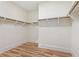 Walk-in closet with a wood floor and white walls with molding at 14906 Speer Lake Dr, Winter Garden, FL 34787