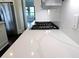Close up of the quartz countertop and gas range in the kitchen at 14906 Speer Lake Dr, Winter Garden, FL 34787