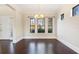 Formal dining room with dark hardwood floors, large windows, and elegant chandelier at 14906 Speer Lake Dr, Winter Garden, FL 34787