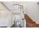 A grand foyer featuring a curved staircase, hardwood floors, and a view of the lake at 14906 Speer Lake Dr, Winter Garden, FL 34787