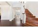 Elegant foyer features hardwood floors, a curved staircase, and a grand entrance with a view to the lake beyond at 14906 Speer Lake Dr, Winter Garden, FL 34787