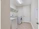 A laundry room with a washing machine, dryer, sink and shelves at 14906 Speer Lake Dr, Winter Garden, FL 34787
