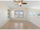 Bright living room with wood floors, modern ceiling fan and a water view at 14906 Speer Lake Dr, Winter Garden, FL 34787