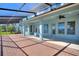 Spacious covered patio featuring brick flooring and picturesque views of the lush backyard and serene lake at 14906 Speer Lake Dr, Winter Garden, FL 34787