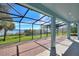 Covered outdoor patio with brick flooring, offering a serene space with views of the beautiful lake at 14906 Speer Lake Dr, Winter Garden, FL 34787