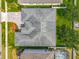 Aerial view of the home's roof, showcasing its unique design and layout amidst lush greenery at 17146 Cypress Preserve Pkwy, Orlando, FL 32820