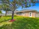 Lush backyard featuring a screened lanai, green lawn, and white privacy fence at 17146 Cypress Preserve Pkwy, Orlando, FL 32820
