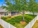 Well-maintained backyard with mature trees, green lawn, and white fencing at 17146 Cypress Preserve Pkwy, Orlando, FL 32820