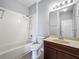 Clean bathroom with a white tiled shower-tub, toilet, and vanity with granite countertop at 17146 Cypress Preserve Pkwy, Orlando, FL 32820